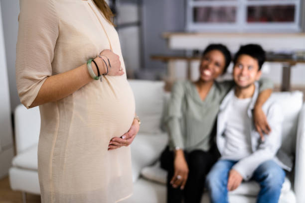 Pregnant Woman Touching Her Belly's Woman Standing In Front stock photo