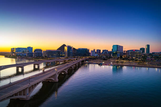 Tempe Skyline Aerial With Lake And Bridges At Dawn Downtown Tempe, Arizona at dawn with bridges and Tempe Town Lake in the foreground.  Tempe is part of the Phoenix Metropolitan Area. tempe arizona stock pictures, royalty-free photos & images