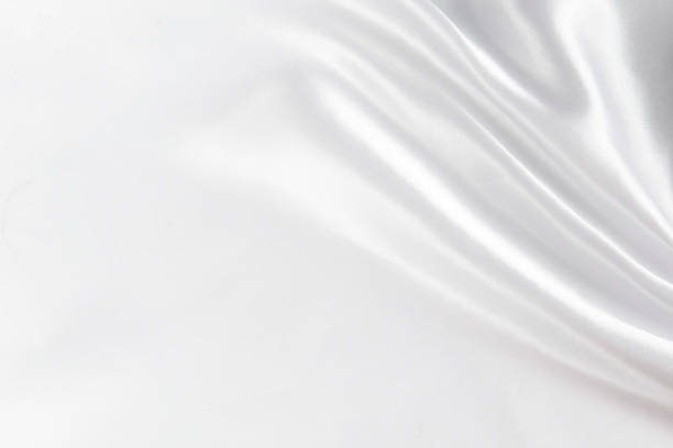 istock Abstract white silk fabric texture background. Cloth soft wave. Creases of satin 1384687311