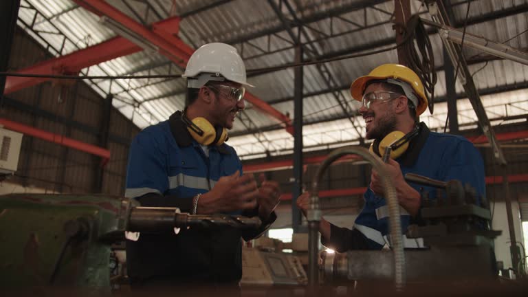 Two engineer people staff work with lathe machine and finished their work feel happiness after success task. Successful cooperation teamwork and good positive motivate