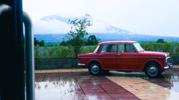 istock mountain view with parked red vintage car 1384696775