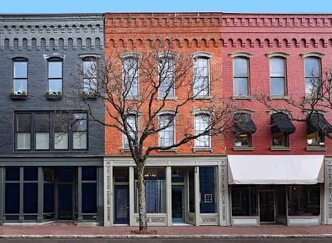 Traditional American 19th century style main street brick building with apartments upstairs and stores on ground floor