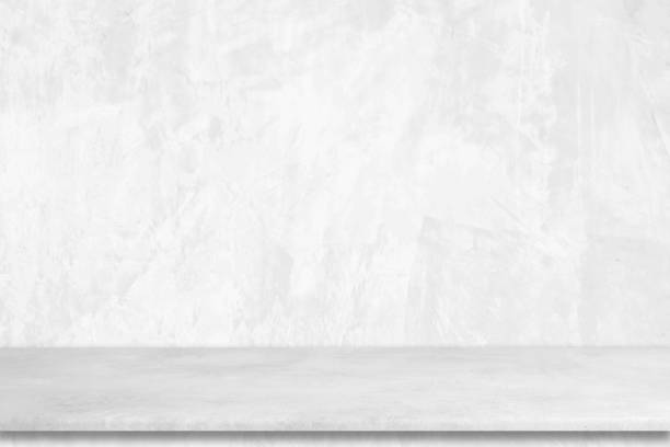 istock Empty white cement table over white cement concrete wall background, banner, table top, shelf, counter design for product display montage 1384700297