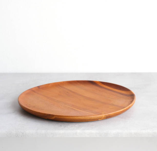 istock Empty round wooden plate on gray cement table background, banner with copy space, Blank wood tray for food display montage, template, mock up, top view, flat lay 1384700354