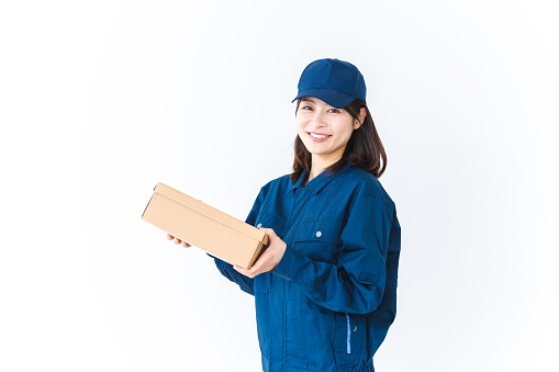 Delivery woman delivering package with smile