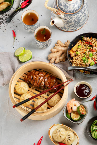 Assorted Chinese food set on light background.