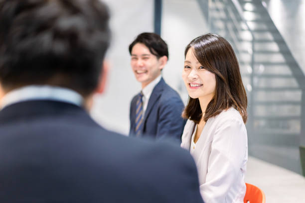 istock Young businessperson facilitating a meeting 1384702174