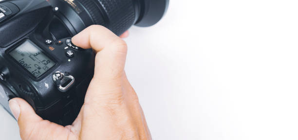 istock Photographer hand about to click the shutter button of digital DSLR camera 1384707989