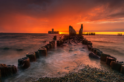 Dramatic sunrise over the sea. Famous place on the Baltic coast, beach near the old torpedo plant from World War 2