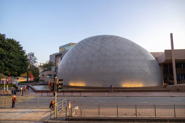 Hong Kong - March 10, 2022 : People walk past the Hong Kong Space Museum in Tsim Sha Tsui, Kowloon, Hong Kong. It is an astronomy and space science museum.
