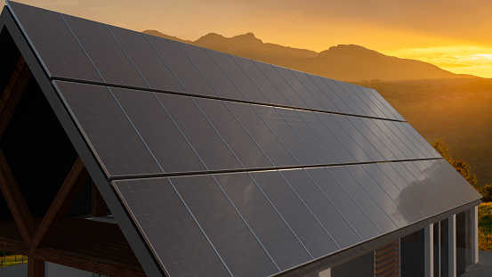 Photovoltaic panels on the roof of the house during a beautiful sunset