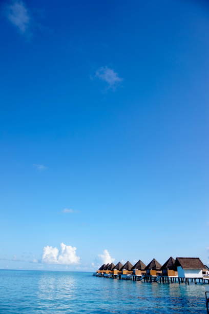 Shot in a Sunny day. Overwater villa located at Indian Ocean. The sky is clear and blue. The sea is blue and clam.