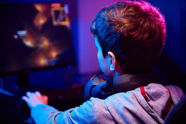 istock Boy plays computer game at home, gaming addiction 1384738780