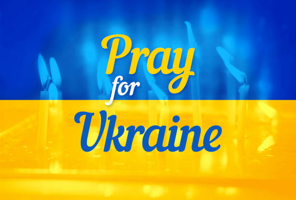 Pray for Ukraine – abstract concept for political conflict with the Ukrainian national flag. stock photo