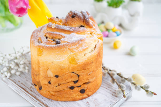 istock Easter composition. Traditional Russian and Ukrainian Easter cake - Cruffin, Kraffin or Kulich with chocolate and candied fruits on a white wooden background. Paska Easter Bread. Selective focus. Copy space 1384745023