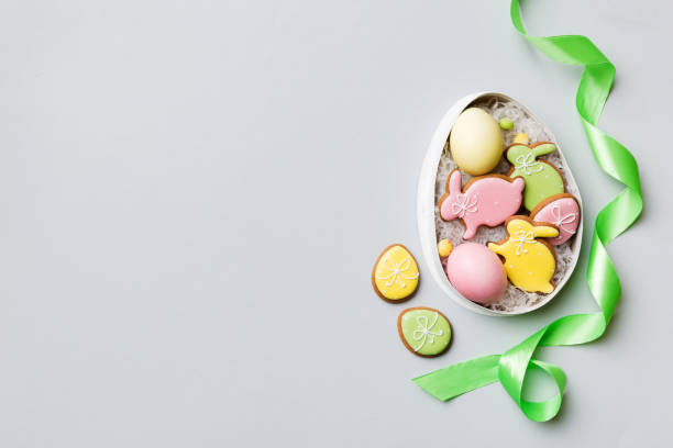 istock Colorful easter cookies in basket with Multi colors Easter eggs on colored background . Pastel color Easter eggs. holiday concept with copy space 1384747892