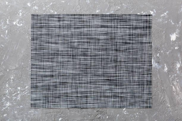 istock Top view of grey tablecloth for food on cement background. Empty space for your design 1384747965