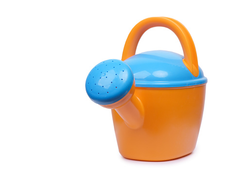 Plastic watering can toy isolated on white background