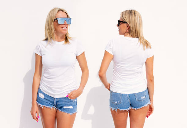 istock Woman wearing blank white t-shirt, front and back view 1384755050