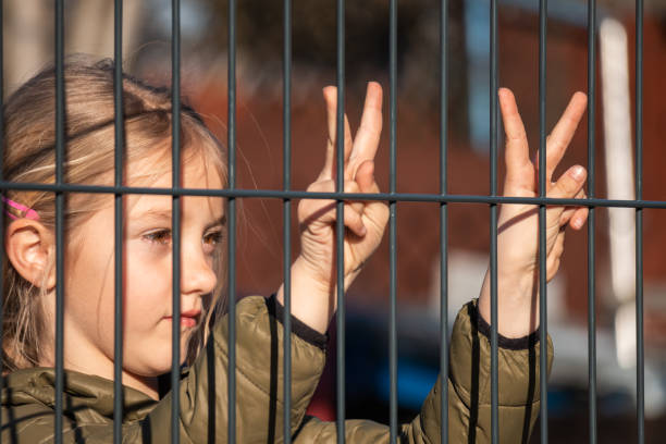 istock Child refugee showing peace sign 1384757032