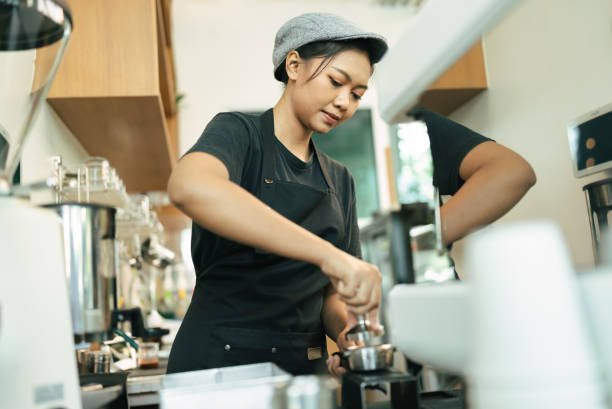 istock Woman barista cafe coffee uniform apron make coffee 1384757286
