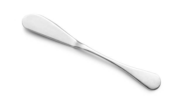 istock Knife spreads butter and jam on white background. 1384769725