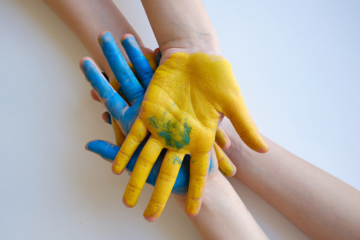 Children's hands are painted yellow-blue. Stop War. Children against war. Independence of Ukraine. Flag. Ukraine love concept. Children of Ukraine