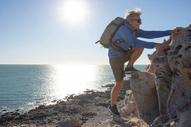 He climbs up to coastal viewpoint