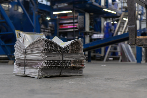 Newspaper printing press , newly printed newspapers ready for distribution