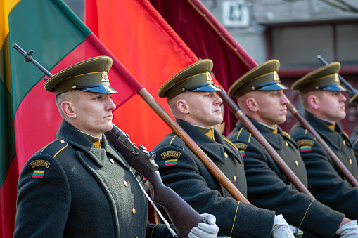 Vilnius  Lithuania - March 11 2022: Soldiers in official uniforms march through the streets of the capital Vilnius, Lithuania with national flags, March 11 Independence Day