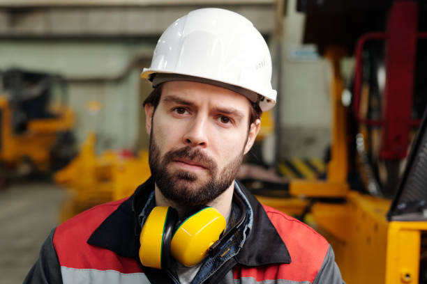 istock Serious engineer of industrial plant looking at camera 1384786220