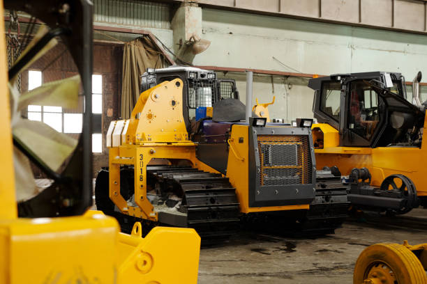 istock Group of huge road construction machines with caterpillar tyres 1384786232