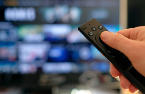 istock Remote control and screen - binge watching the favorite TV show 1384787670