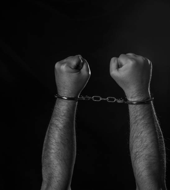 Hands in handcuffs stock photo
