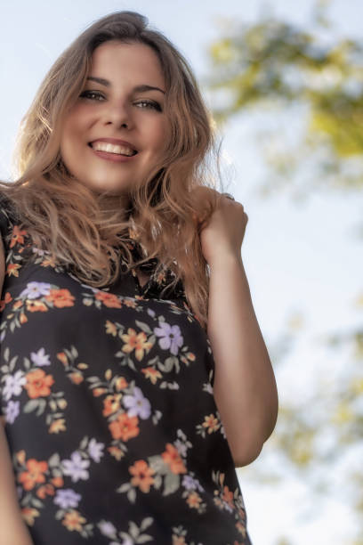 istock Beautiful  young woman is posing outdoors. Vertically. 1384800050