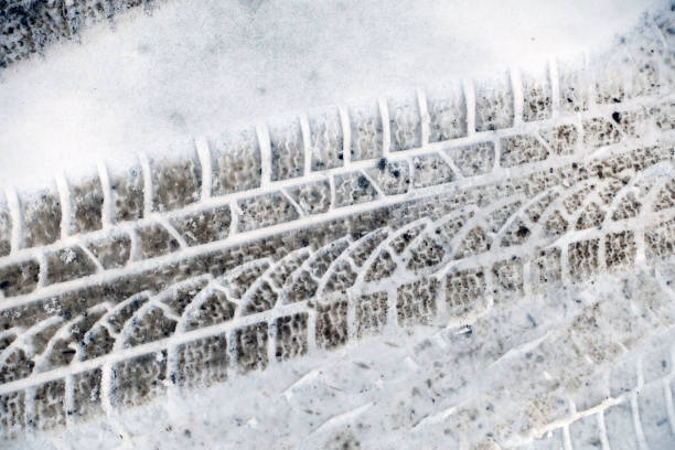 istock automobile ruts prominently formed on the snow, 1384805735