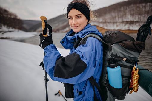 Woman can't hide her excitment about how great she feels during her winter hike on a snowy mountain