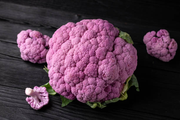 istock Purple colourful cauliflower on black wooden table 1384807843