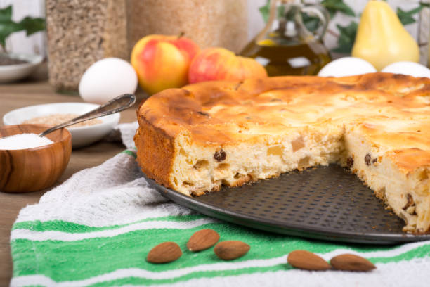 Cheesecake with raisins and apples on a table with ingredients