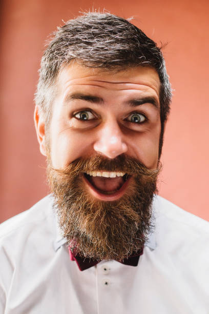 istock Bearded happy man smiling at all 32 teeth. 1384816638