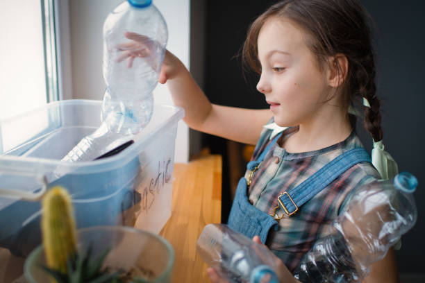 istock Girl  sorting out waste for recycling 1384818650