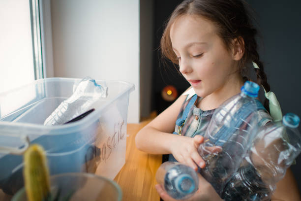 istock Girl  sorting out waste for recycling 1384818912