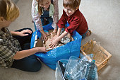 Family  sorting out waste for recycling