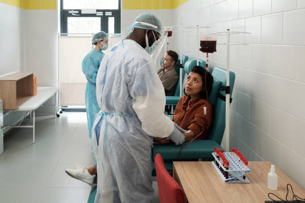 jeune donneuse hispanique regardant un clinicien afro-américain - dialyse photos et images de collection