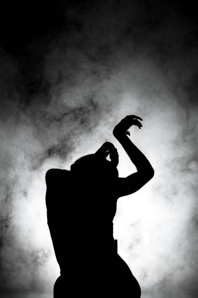 istock silhouette modern ballet dancer posing on dark background with smoke 1384821923