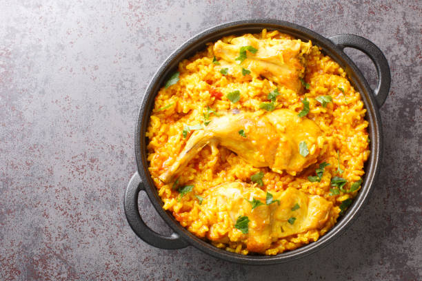 istock Fragrant rice with vegetables and rabbit meat close-up in a frying pan. horizontal top view 1384823856