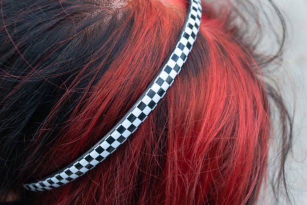 Punk emo girl, young adult with black red hair Punk emo girl, young adult with black red hair, close-up, horizontal black hair emo girl stock pictures, royalty-free photos & images