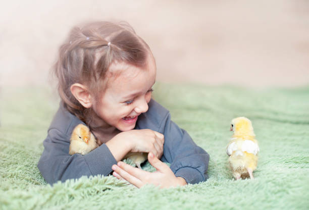 istock little girl and chickens 1384828285