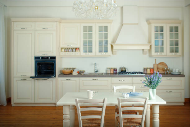 istock Spacious bright kitchen with a dining table in the center of the room 1384828459