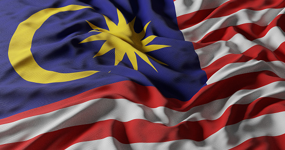 Malaysia Flag, Jalur Gemilang waving with the background of Malaysian rainforest trees.Malaysia Flag, Jalur Gemilang waving with the background of lake and Malaysian rainforest trees.